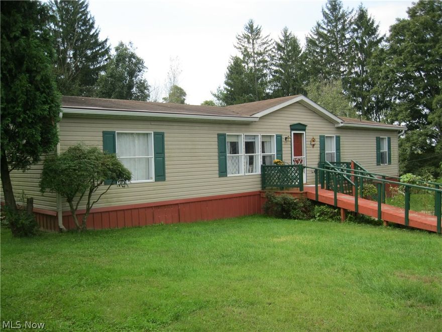 Enjoy the country setting? Look no further. Beautiful ranch home featuring 3 br's, 2 baths, LR, great room w/fireplace, DR w/slider to lg deck-handicap accessible, darling kitchen w/appliances, laundry room.  Quaint barn for storage plus 2 other outbuildings. Enjoy the beautiful flower garden/patio.  Call today, priced to sell.