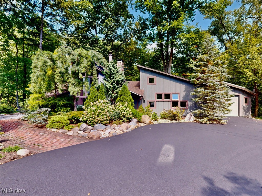 Modern Hillside Retreat Overlooking Big Creek Waterfalls
Perched on the desirable Cascade Road hillside, this extraordinary contemporary home offers an unmatched blend of modern design and natural beauty. Overlooking Big Creek Waterfalls, it's a one-of-a-kind retreat where architecture meets Mother Nature's masterpiece.
Step inside to a stunning open floor plan with vaulted ceilings, warm wood accents, and walls of glass that flood the home with natural light. The foyer opens to a dramatic vaulted great room with a corner stone fireplace and wood ceilings, setting the tone for the home's inviting yet sophisticated style.
A gourmet kitchen with SieMatic cabinetry, newer appliances, and seamless flow to the dining room makes entertaining effortless. Sliding doors from both the kitchen and dining room lead to a spacious deck, perfect for outdoor dining, picnics, or simply listening to the soothing sound of the falls.
The vaulted owner?s suite is a true retreat, featuring a 14x12 dressing/sitting room, fireplace, spa-inspired bath with oversized shower, and of course, breathtaking views of the waterfalls.
Beautifully maintained and thoughtfully updated, the home has been remodeled in 2002, 2013, 2014, and most recently in 2025 with brand new windows and electric blinds. Outdoors, extensive landscaping enhances the private, wooded setting. Spend the day exploring the creek, casting a fishing line, or setting a chair in the water to relax, it's a lifestyle unlike any other.
Secluded and serene, yet just minutes from shopping, dining, and city conveniences, this property offers the perfect balance of privacy and accessibility.