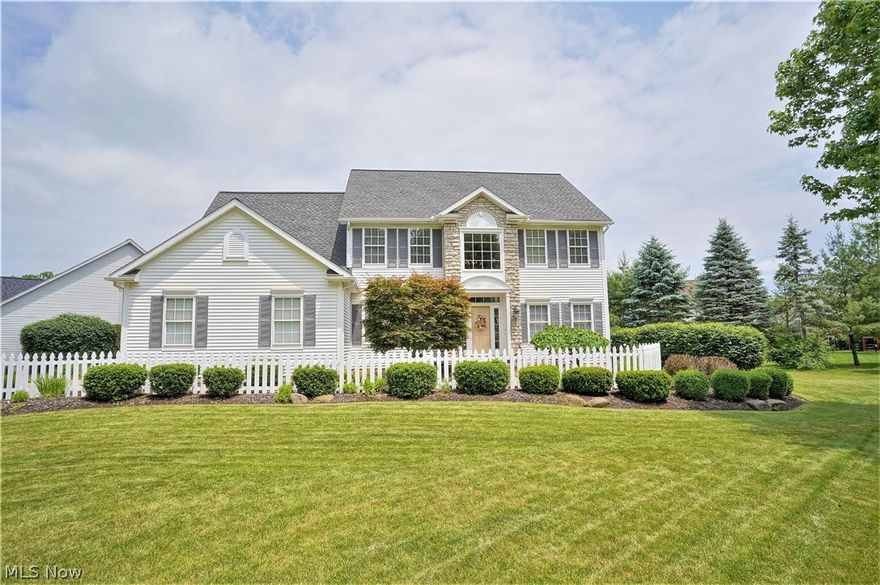 Welcome to this stunning Colonial in The Villages at Fairlawn! The home has been meticulously maintained. Exterior features include a covered stone entry, gardens surrounding three sides of the home and a  three car garage. Enter the two story foyer and notice that natural light fills the main floor. This home features white trim, fresh paint, and hardwood floors in the foyer leading into the kitchen. On the left, a library provides a quiet work-from-home space, and on the right, a living and dining room area are separated by columns. The kitchen is the perfect gathering space with hardwood floors, white cabinetry, granite countertops, subway tile backsplash, and stainless steel appliances. Off the kitchen, the family room has vaulted ceilings and a raised hearth wood burning fireplace with gas starter. Atrium doors provide easy access to the deck and patio, overlooking the fountain in the professionally maintained pond. This is a peaceful space for enjoying morning coffee and for ente