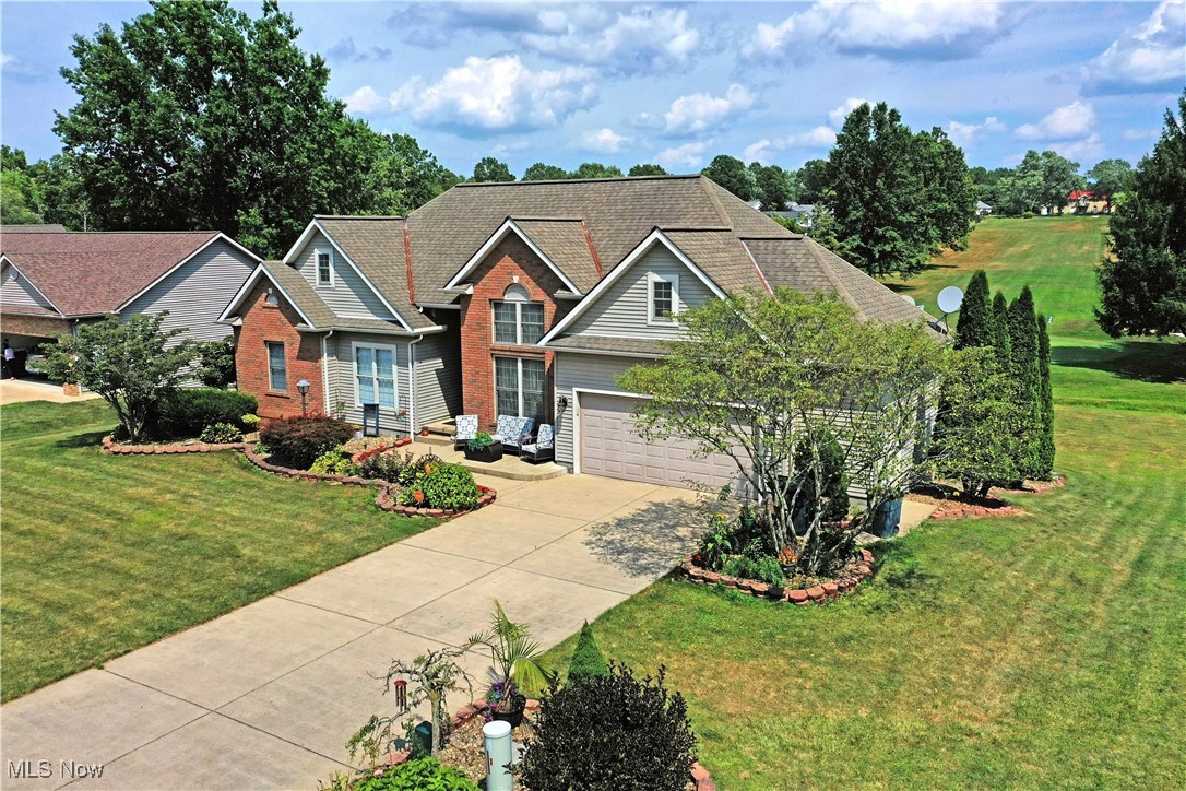 Surround yourself in opulence as you explore one of Champion’s most desirable locations! With the Cranberry Hills golf course right in your backyard, this marvelous estate brings an experience like no other. The secluded neighborhood is set off a dead-end road, just moments from downtown attractions. A cement driveway is marked by flowering landscaping as the handsome brick work adds to the curb appeal. A stone lined mulch bed runs past a front patio as it sweeps up to the decorative entry door. Meanwhile, the backyard delights with a second story deck set off the kitchen, the perfect scenic overlook as you enjoy the early evening hours. Inside, the tiled foyer transitions into dark hardwoods as the rich colorways set a dramatic tone. A forward dining space resides under a stepped ceiling with a corner pillar divider. Large windows line the far wall, offering two tiers of glass to match the dining area. The gas fireplace is located before the unique rear stairway and loft styled entrance. Meanwhile, the elaborate kitchen splits from the living room to offer a prominent center island and casual dining with sliding doors opening to the rear deck. Past the foyer, the main hall transcends a trio of spacious first floor bedrooms along with a tastefully appointed full bath. The must-see master bedroom treats you to great backyard views and a masterfully executed full bath with its unbelievable stone and glass sculpting; truly artful. Downstairs the central family room offers an additional fireplace with adjacent laundry services and shop room with basement walk-out. A third full bath joins three additional bedrooms, bringing the total to six. Call today to be first through the door!