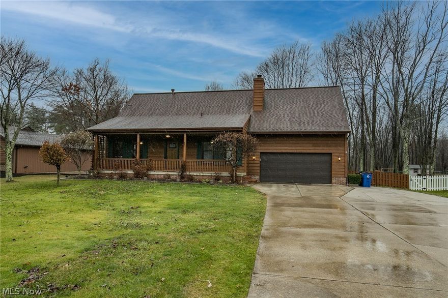 Welcome home to this beautiful, 4 bedroom, colonial style home in the very desired Strongsville area!  This home is nestled on a private ¾ acre lot that includes fenced in yard, an extra detached 2 car garage and a large deck to enjoy the wooded scenery.  Covered porch takes you to the front door.  Upon entering,  you are greeted by the inviting, bricked faced, wood burning fireplace.  A great place to warm up on those cold Ohio nights.  A few steps away, is a spacious dining room with beautiful hard wood floors and crown molding throughout!.  The updated kitchen has granite countertops, stainless steel appliances, breakfast island and plenty of cabinet space. French doors lead to the attached back yard deck.  Main floor full bath is located just around the corner.  Upstairs, you will find the master bedroom with plenty of space and ceiling fan. Enjoy relaxing in your jacuzzi tub in the attached master bath!   The remaining  3 bedrooms on the second floor are spacious and lets in an ab