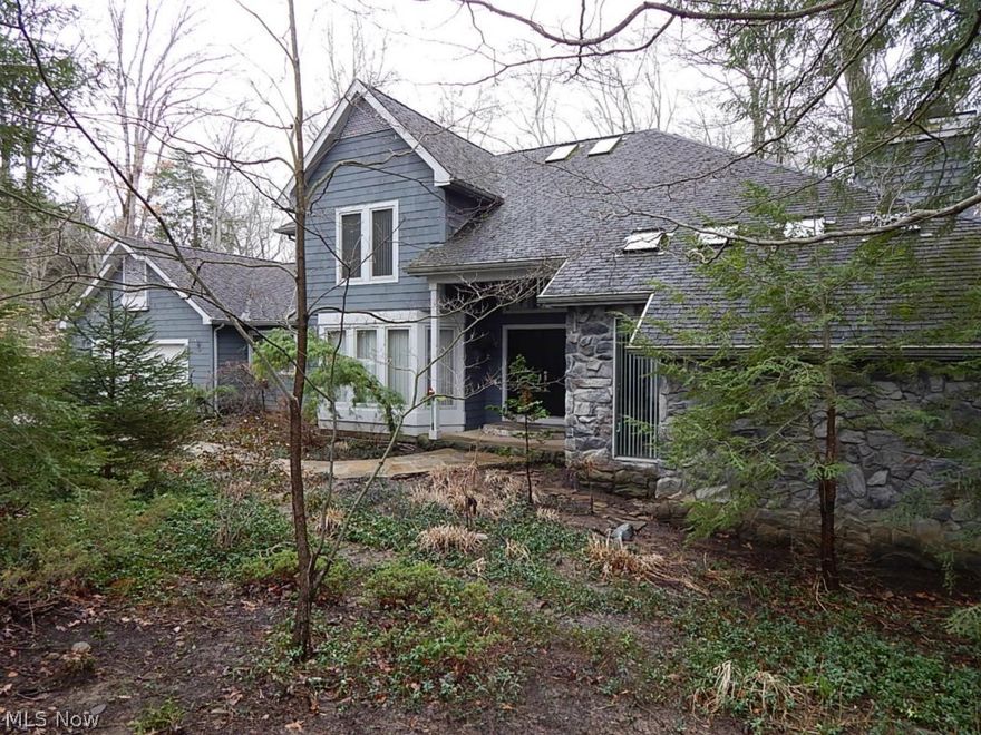 Nature abounds this architect-designed contemporary home on heavily wooded 4+ acre lot overlooking ravine & Yellow Creek.  Walls of windows w/magnificent views.  Wrap-around deck.  Custom oak curved staircase to all 3 levels.  Great room w/soaring ceiling, fireplace, wet bar. Gourmet kitchen w/granite counters & contemporary custom cabinets & eating area.  Formal dining room w/hardwood floor.  1st floor master w/fireplace, glamour bath & 2 walk-in closets.  2nd floor loft  overlooks great room w/views of ravine, 2 additional bedrooms & full bath.  Library w/built-in bookcases. Home wired for sound.  Lower level features family room fireplace, wet bar and sliding doors to stone patios.  Sunken hot tub in “spa area” surrounded by windows overlooking trees & ravine. This level features 4th bedroom w/2 closets, an office and a full bath.  1st floor laundry/mudroom w/staircase to unfinished basement area w/2 furnaces, hot water tank, central vacuum, water softener and walls of shelves for s