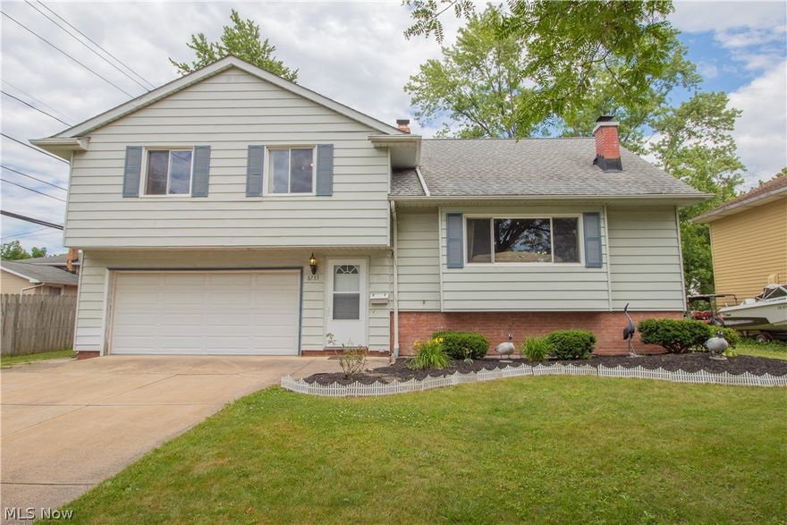 This 4 level split boasts quality craftsmanship with modern touches.  Crown molding, recessed lighting and beautiful hardwood flooring throughout the house.  Spacious living room with a lovely picture window for loads of natural light, wood stove fireplace with fan provides warmth in the winter, kitchen with a large center island, stainless steel appliances and granite counter tops.  The second level features 3 bedrooms, a master with 2 closets and glamour bath, a spacious 4th bedroom is located on the next level.  The finished lower level has an elegant family and utility room with tile flooring.  Conveniently located by shopping, the hospital, Tri-C/schools, dining and public transportation. Home warranty included for peace of mind.