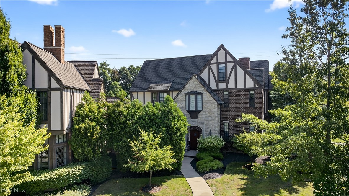 Welcome to Kirtland Tudor Estates
This elegant townhome, built in 2008 by Payne & Payne Builders, showcases classic Tudor architecture and refined craftsmanship. Featuring 2 bedrooms, 2 full baths, and 1 half bath, the home offers heated floors throughout key areas, including the foyer and bathrooms.
The open-concept layout includes a dramatic two-story Great Room with floor-to-ceiling windows, custom treatments, and a see-through gas fireplace. Adjacent is a versatile 16' x 13' room with crown molding and sconces ideal as a study, library, or formal dining room.
The gourmet kitchen boasts marble countertops, custom cabinetry, high-end appliances, farm sink, breakfast bar, and a charming dining nook. Vinyl wood flooring flows throughout the main living spaces.
A sunroom or family room opens to a walk-out rooftop courtyard. The spacious primary suite features large windows, a walk-in closet, ceiling fan, and a luxurious bath with heated floors, soaking tub, shower, and bidet. An additional flex space is perfect for a home office.
The second bedroom includes a private full bath with heated floors. Additional amenities include a laundry room with washer and dryer, a pantry/storage room.
"Versatile finished attic on the third level—ideal for a home gym, office, or storage.
The home also offers a two-car attached garage. Located in a gated community within the Kirtland School District, directly across from Kirtland Country Club and minutes from Historic Downtown Willoughby and near I-90."