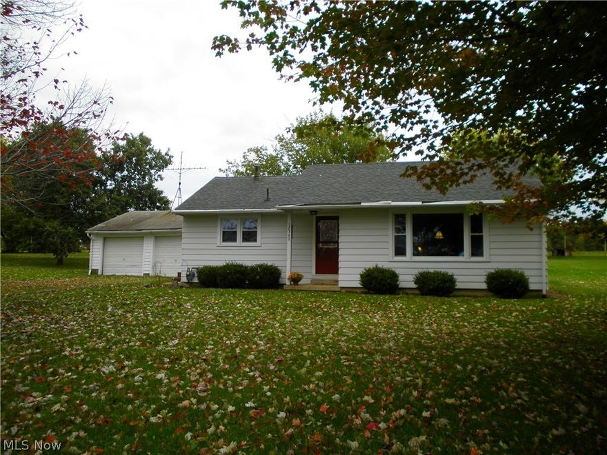 Ranch home in South Range School District.  This home features a living room with hardwood floors, kitchen with all appliances , 2 bedrooms, bath., and laundry room. Natural gas for heating, central air, water softener. New windows throughout home in 2014. Side porch, back patio, fire pit in back yard.  Two car detached garage with lots of storage.  New electric service in garage.  Electric dog fence.  Nice country setting. Convenient location.  Call to see this home.