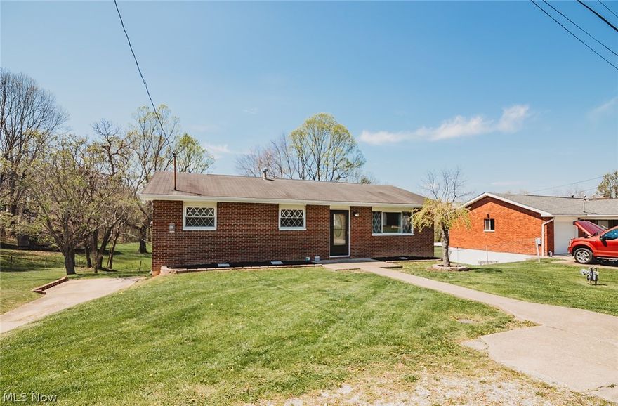 Fantastic location on a quiet dead-end street with a beautiful wooded backyard!  This brick ranch is move-in ready and features several upgrades throughout.  Enjoy a nicely updated kitchen with all black stainless steel appliances, and updated bathroom, fresh paint, and new lighting throughout the home.  Mostly hardwood flooring adds warmth and character.  The home also features a full walkout basement with a cozy wood-burning stove, offering lots of extra storage space on the lower level.  Step outside to the huge covered back deck overlooking the beautiful yard.  Perfect for relaxing or entertaining.  A wonderful home in a peaceful setting.  Ready for its next owner.