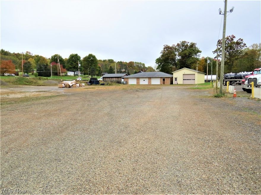 Level 2.6 Acre Property with Buildings on St Rt 43 North of Carrollton, Ohio! NO ZONING and HIGH VISIBILITY! Traffic counts of over 6000 per day. Located at the corner of the Canton Rd and Arrow Rd intersection.  Large stoned lot suitable for heavy trucks with easy road access from St Rt 43 or Arrow Rd. Property features a good 2008- 24 x 48 metal sided building with shingle roof , 2- 12'W x 10'H overhead doors, insulated , carpeted floor, heat and central AC; this building is set up to drive through. Also a good 1976 brick 33' x 55' building with shingle roof, 3- 10'W x 7'H overhead doors, heat and central AC , half bath, and tall ceiling in one bay suitable for a car lift. These structures are well maintained and adaptable to many uses. Single phase electric in the buildings currently, but 3 phase is nearby. Property has a water well and septic. This was formerly a used car business site. Lots of possibilities here! Seller does not own minerals. Call to schedule your viewing!