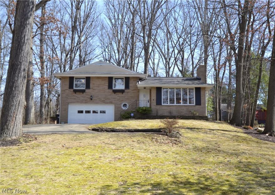 Very nicely maintained, solid brick home at Lake Cable. Nestled on a private wooded lot. Dining room adjacent to the kitchen with access to the three season enclosed porch to the rear of the house and overlooks the beautiful wooded view. Abundance of natural light in the living room, which also offers a stone fireplace. Three good sized bedrooms and full bath on the second floor.  Lower level recreation room with fireplace; access to second full bathroom and spacious laundry room area. Previous owners disclosed the roof replaced in 2014, and furnace 2012. Special features and updates since 2016: New electric breaker box, radon mitigation system, basement facelift (new lighting and vents, ceiling and walls painted, glass block windows, 220 line for the dryer), new garage man door installed 2018, Living and dining rooms (all ceilings,trim, and walls painted, new outlets and switches, registers), bedrooms and hallway (newly painted ceilings, trim, and walls, new outlets and switches. All