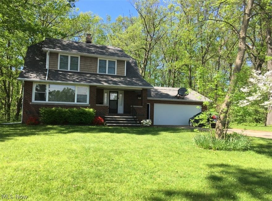 Charming 3 bedroom brick home has a lot to offer. Beautiful woodwork throughout, large rooms, updated kitchen, enclosed front porch, paved driveway & attached 2 car garage. Situated on a double lot home features, newer windows, roof only 8 years old. Solid wood flooring throughout (under carpet) Small patio out back. Gas forced furnace & central air. Great home at a great price! Put this one on your list to see soon.