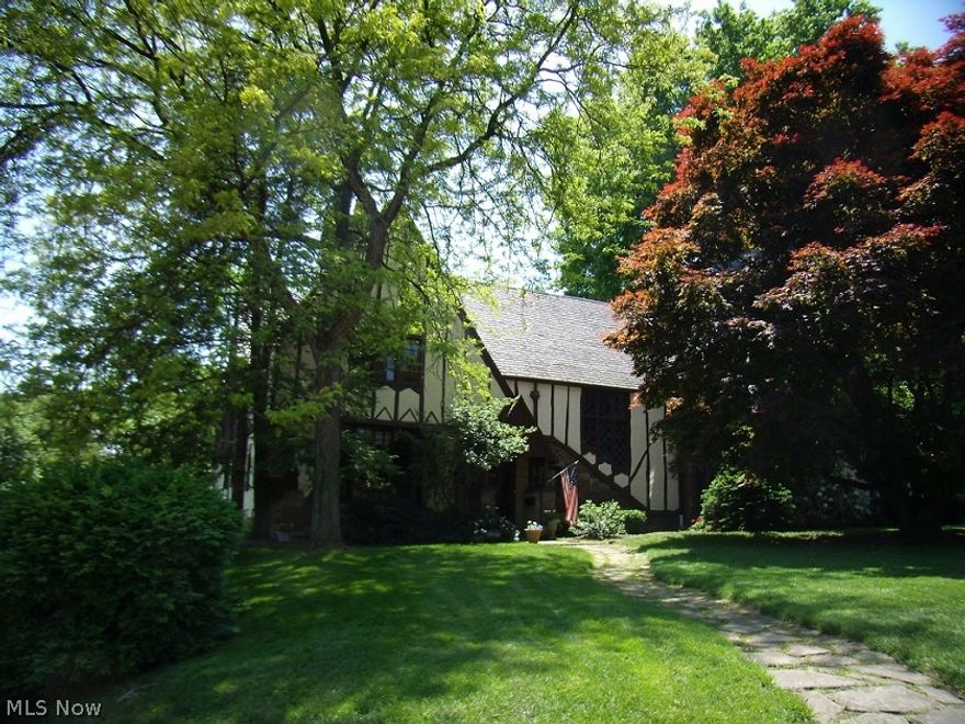 Classic Historic Ridgewood Tudor in impeccable condition. Updated throughout while still maintaining the authenticity & architectural beauty of an older home. 4 bedrooms, 3 full and 2 half baths. Gorgeous hardwood floors, solid doors, ornate moldings & trim. Large formal living & dining rooms with fireplaces. Warm den/study with beautiful built-ins. Modernized kitchen has white cabinetry, solid surface countertops, stainless appliances & island with breakfast bar. Rare first floor laundry room/mudroom! Fabulous master bedroom suite with dressing area & completely updated bath. Spacious secondary bedrooms with abundant closet space. Great "club-style" recreation room with fireplace and wet-bar. Beautiful screened porch overlooks the park-like yard and patio. This is a very special home!