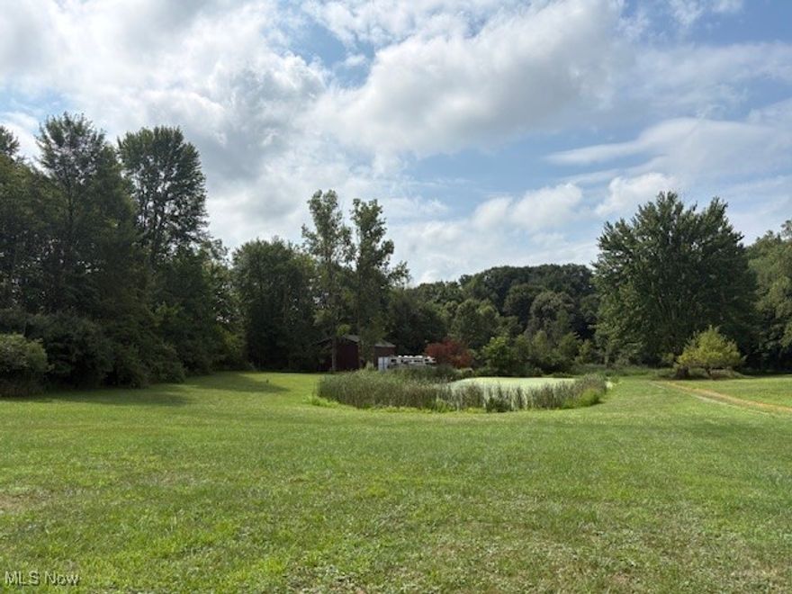 Check out this unique property located on 8.5 acres in Suffield Twp. Many possibilities. There is a 32x48 outbuilding built in 1992 on the property. The main floor has 1536 sq. ft. with concrete floor, electric and 3-10ft. garage doors. The second floor has a 1 bedroom apartment area with about 600 sq. ft. finished. It has a full bathroom with laundry hook-ups, kitchen and large living room. There is also a large pond on the property. With 8.5 acres, there is plenty of room to farm, build another property or use in its current condition. About half the property is cleared and about 5 acres wooded in the back. This property will make an amazing storage/workshop and is big enough to build your dream home with its current amenities.