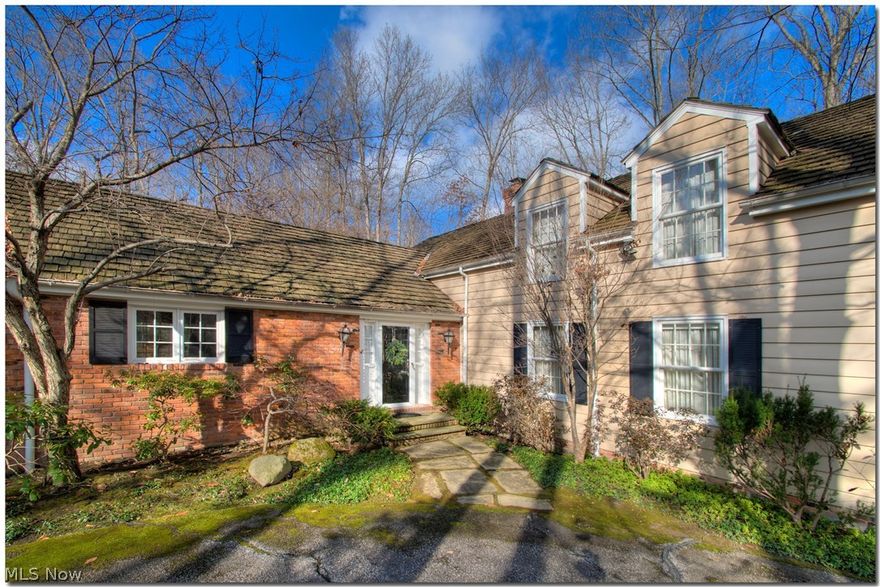 This charming Western Reserve Colonial is nestled on a most idyllic setting. Look out any window and nature abounds.  Special features include the master bedroom on the first floor with his/hers walk-in closets.  There is a cozy study off the hall just outside of the master bedroom.....the perfect spot for curling up with a good book in front of the brick fireplace.  The generously sized living room features a more formal fireplace and has beautiful views.  Off of the living room is a year round sun room with windows that let the outside in.  Off of the sun room is a beautiful stone patio.  The current owner has won awards for his landscape design.  The second floor features three bedrooms and two full baths.  The icing on this cake....the owner has had the old wallpaper stripped and has invested $10,000 in beautiful new paint throughout; and $10,000 for all new carpet.  Don't miss this gem of a home.