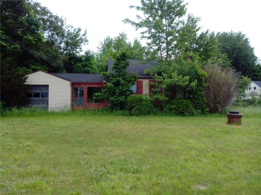 Property is almost 15 acres between two parcels. House has not been occupied for years. There is a separate garage on the larger parcel.  Great location with lots of potential.  Parcel frontage is aprox. 101.98  + 42.30 = 144.28 feet  then separate 36 feet and opens up in the back. Property sits across the street from Walmart and next to Deans restaurant. Bring your creative ideas.