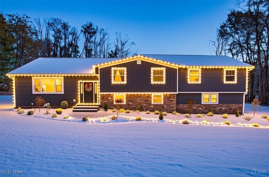 Welcome to 12005 Auburn Rd, where Luxury New Construction meets tranquil Munson Township living, with NO RITA TAXES! This five-bedroom, 3.5-bath modern farmhouse has been completely rebuilt from the ground up — every system, surface, and detail is brand new. Experience the peace of mind of new construction quality without the wait.

Step inside to an open-concept great room with vaulted ceilings, skylights, and a stunning 5-foot linear fireplace that instantly feels like home. The gourmet kitchen is a showstopper — featuring a massive 10-foot center island, custom Shaker cabinetry, tiled backsplash, granite countertops, and a huge eat-in area ALL with amazing panoramic views 

The primary suite is pure luxury with a huge 15x8 walk-in closet and a spa-inspired bathroom featuring a custom tiled shower with multiple shower heads and body jets. Upstairs, another bedroom offers a private ensuite bath — perfect for guests or family. Every inch of this home was reimagined — from the new roof, siding, windows, plumbing, and electrical, to the tankless hot water system, furnace, air conditioning, Heated Oversized Gargage with new doors, openers, and Epoxy floors. Other mechanical updates are the New Kinetico water treatment system & Septic. Even the foundation was rebuilt with new block walls, offering true like-new construction integrity.

Set on 1.75 private acres, the property backs up to the peaceful woods near Bass Lake, offering beautiful year-round views and a true sense of nature and privacy. Outside, enjoy a new driveway, fresh landscaping, and stamped concrete patio — perfect for entertaining or quiet mornings with coffee.

Every part of this home looks and feels Brand New — because it is! Whether you’re looking for modern craftsmanship, low-maintenance living, or a peaceful escape just minutes from  Chardon Square and Alpine Valley Ski Resort this is the home that checks every box. WOW!