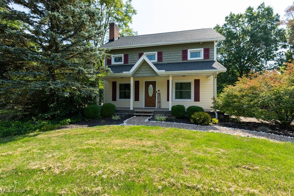 We welcome you to 2.48 wooded, professionally landscaped acres in sought-after Columbia Township. This modern farmhouse-style 4-bedroom, 2.5-bath home blends privacy, functionality, and timeless charm in a scenic, park-like landscape with no HOA fees or RITA taxes. Follow the woodland-inspired stone path to the inviting full-length covered front porch. Inside, the home features newer flooring, abundant natural light, thoughtful updates, and a freshly painted interior. The living room showcases a brick wood-burning fireplace for cozy evenings and flows into an open-concept dining room filled with sunshine. The kitchen offers solid wood cabinetry, Corian countertops, stainless-steel appliances, and a pantry. The great room features a beamed ceiling, bay windows & peaceful views, access to the back porch, and a built-in desk tucked into a quiet space. Bathrooms are spacious and finished with crown molding and a warm palette. A rare gem is the 28x28 fully electric barn-inspired outbuilding, ideal for entertaining, creative space, or storing vehicles and equipment. It includes a loft with staircase, a covered 20x8 porch, and both standard and oversized garage doors for flexible use. The attached oversized garage is heated and cooled and features newer doors, openers with battery backup, and springs, making it as functional as it is comfortable. The lower level includes laundry, an additional shower/pet-wash area, mechanicals, generous storage, and walk-out to the garage. Updates include a smart thermostat with WiFi-control, and, electric water heater. A nostalgic milk house adds charm to this naturally beautiful and impeccably kept property. Vinyl siding and upgraded underground drainage enhance the low-maintenance exterior. While peaceful & private, the home is minutes from shopping, restaurants, and daily conveniences.