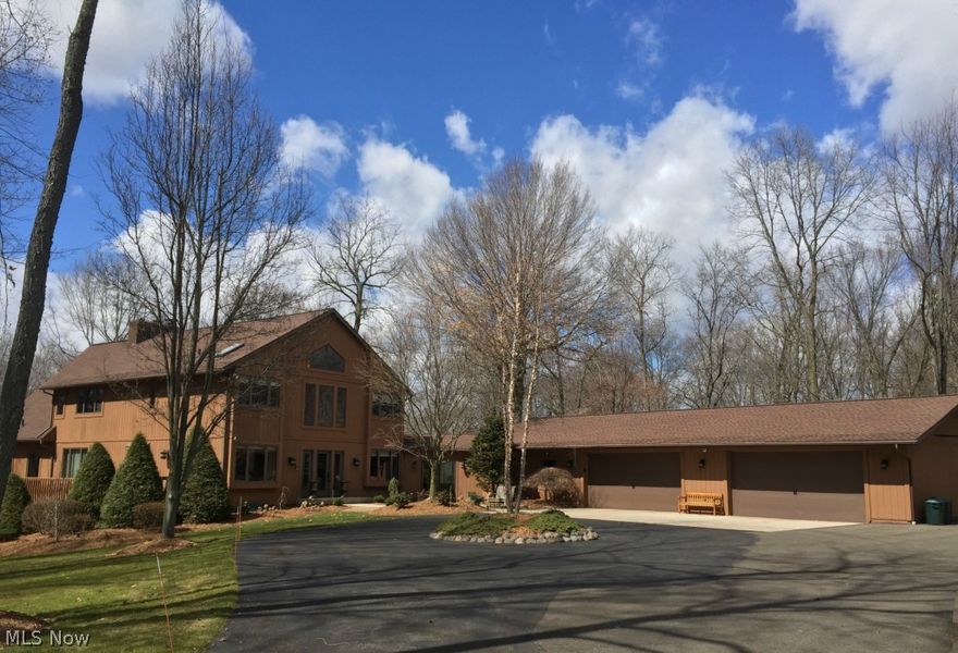 Secluded Tuslaw Beauty – Nearing Canal Fulton and Wayne/Summit county borders.  Truly a rare find with attention to detail and quality amenities. This exquisite 7.5 Acre Estate includes  a finished walk-out lower level w/In-Law suite!  Recent improvements make this home like new inside and out w/all new windows, updated mechanics, renovated master bath, neutral décor and more! Gorgeous granite kitchen is just loaded with extras… oversized island, buffet counter, walk-in pantry, dinette,  appliances and elegant formal dining rm.  You’ll love the 6+ car garage and 31x15 sunroom/breezeway!  Beautiful atrium foyer, first floor den & laundry with built-ins.  Spectacular great room with soaring ceiling, stone fireplace, an abundance of windows and sliding doors to a wrap-around 2 story deck.  New master bathroom renovation with walk-in custom tile shower is just amazing! Possible 10 acres total with full price. There are so many quality features…call today…won’t last!