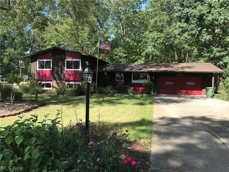 This 4 bedroom 3 full bath home located in Tallmadge schools and Woodland Estates subdivision is now available and looking for a new owner. This is not your typical split level home and comes with a very nice open floor plan. Enjoy the large kitchen with ceramic tile that opens to the dining room and a large great room with a vaulted ceiling and a large beam. This great room also has a ton of natural light from all of the windows that allow you to see the backyard and your own wooded area that mother nature has provided. The master bedroom comes with a full bath that has been updated and a large walkout deck for you to enjoy as well. 2 other bedrooms and another updated full bath are located on the 2nd floor as well. The lower level has the 4th bedroom, the 3rd bath and a large family room with a wood fireplace. There is a lower level walkout with french doors to the backyard. The basement also offers an area large enough to store whatever you are bringing with you. The backyard has a