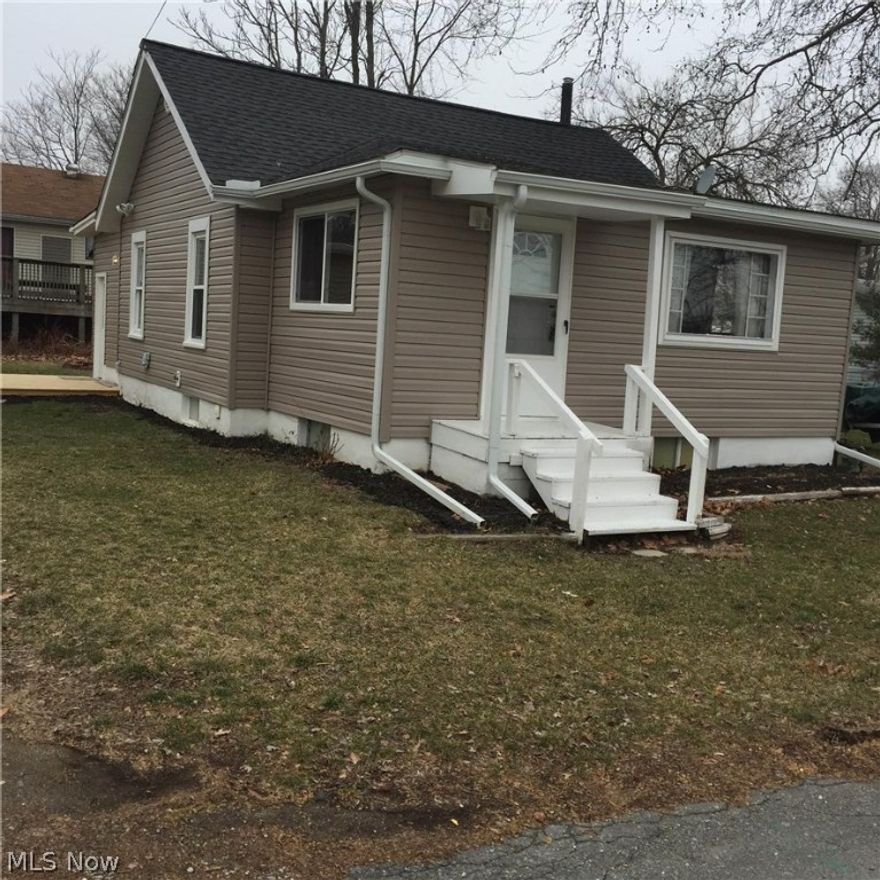 Charming three bedroom  home in the heart of Portage Lakes!   Sits on a DOUBLE LOT to have room for boats and other "toys". Huge, 720 sq ft, 2-car garage/pole building.  Oversized bright and cheery kitchen area and living rooms gives off lots of natural sunlight with it's giant windows.  Extra dry basement with additional rooms for all of your storage needs.  Easy access to boat ramps and lake.