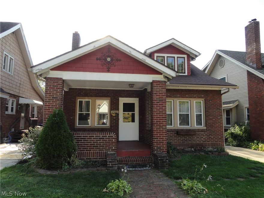Charming brick bungalow with many desirable features.  Welcoming front porch, formal living room and dining room with laminate floors.  Built in cabinets & wood burning fireplace.  Cute kitchen with Corian counters & updated floor.  Updated bathroom beautifully done.  Two bedrooms on first floor and huge bedroom on 3rd floor with 3 closets and a decorative fireplace.  Hardwood floors in all bedrooms.  Newer windows on 1st floor and new roof in 2005.  Concrete driveway, fire pit, partially fenced semi private backyard.