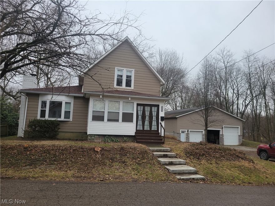 Located on over 3/4 ac. with a completely remodeled home and a large, detached building with many possibilities. The refurbished kitchen has a refrigerator that stays and adjoins the dining area. The living room has a Briar Hill sandstone fireplace with gas log insert. The master bedroom and a new full bath are on main floor. There is a nice enclosed front porch. Upstairs you will find 2 more bedrooms with a full bath. This home was completely remodeled with many new features. Outside you will find a 12 x 22 car port and another storage building along with a very good 40 x 48 garage built in 2007 which is insulated and has gas heat, water and drains. The garage has high ceilings, a walk-in door and 3 overhead doors, 2 with openers. There is also an upstairs parts and storage area with storage racks. This garage will be available with many of the tools the prior owner/mechanic left. There is a direct lift, air compressor with air lines run through out, floor jack, parts washer, small crane lift, and lots of hand tools all which remain with the property.  All this sets on over 3/4 ac with 226 ft of frontage. If you are a handyman or mechanic, then you better check this out!