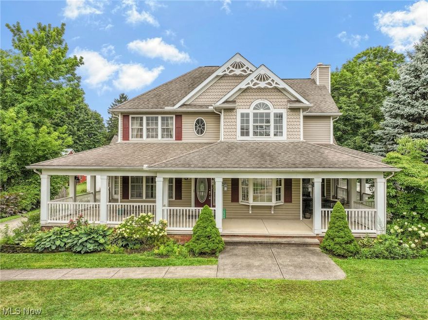 Discover your dream home in the heart of Burton Village, just steps from charming Burton Square. This custom-built home boasts Victorian accents and a wrap-around porch accessible from every room on the first floor. The two-story great room features a stunning wood-faced accent wall above a cozy gas fireplace. The first-floor vaulted primary bedroom offers elegance and convenience, with two sets of French doors leading to a backyard covered porch with a pergola and the wrap-around porch. Indulge in the luxurious ensuite bath with a soaking tub, a spacious ceramic walk-in shower with a seat, and a walk-in closet.

The chef’s kitchen is a culinary haven, complete with a Bosch double oven, Corian countertops, 48-inch cabinets, a Jenn-Air cooktop, and a vaulted eating area. A first-floor laundry room adds to the home's practicality. Adjacent to the kitchen, the formal dining room features a tray ceiling and rich wood flooring, perfect for hosting memorable dinners.

The finished family room in the lower level is ideal for entertaining, offering ample countertop space and an additional bedroom with a large walk-in closet. Overlooking the great room, the loft area with a closet can easily be converted into a bedroom and includes a Jack and Jill full bathroom.

This remarkable property also includes a carriage house with an additional two-car garage, and the upper level measures 31x13, providing endless possibilities. Embrace the elegance and convenience of this extraordinary Burton Village home.