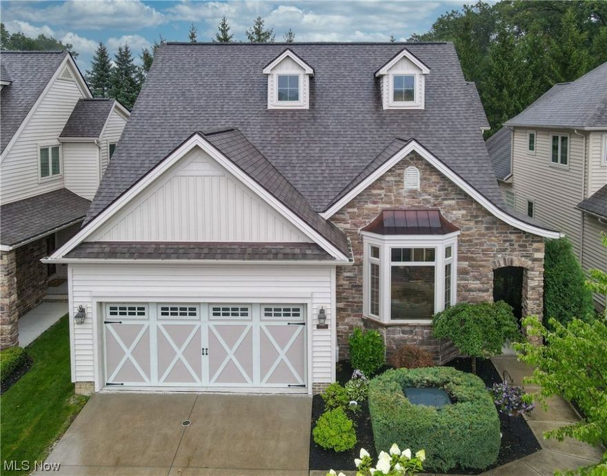 Welcome to this exquisite custom designed cluster home! A masterpiece of professional design and craftsmanship, boasting top-of-the-line products and luxurious features throughout. Mature landscaping adorns the front yard and leads to the private entry into the foyer. A spacious dining area opens into a nicely updated kitchen with center island, stainless steel appliances, bar seating and custom cabinets. The family room with gas fireplace is the perfect area for entertaining and includes large windows + access to the back deck. Adjacent to the kitchen is a private office, providing a serene space for work or study. A convenient mudroom offers ample storage for outdoor gear, while the first-floor laundry adds practicality to everyday living. The main floor owner's suite features soaring 12-foot ceilings and glamor bath with recessed lighting, large soaking tub, free standing shower and dual vanities. The upper level includes a spacious loft area, ideal for lounging, additional entertainment space or second home office. Two generously sized bedrooms share a large, well-appointed bathroom. The lower level has been reimagined and renovated to perfection! A state-of-the-art home gym, screening area and bedroom with a full bath offers flexibility for guests. Completing this lower level oasis is a sleek kitchenette, perfect for preparing snacks and refreshments while entertaining. Many thoughtful and professional updates have been made to this home which makes it a unique and turnkey opportunity. This home is just minutes from shopping, restaurants, and metro parks. Move right in and enjoy!