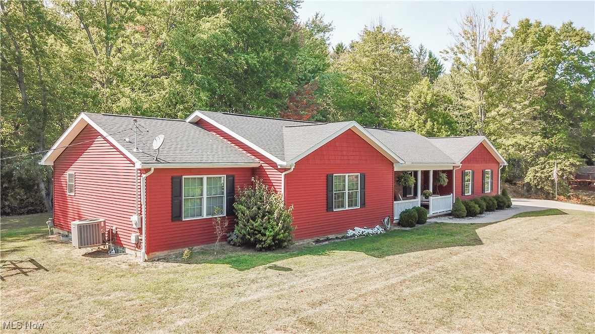 Welcome to this beautifully maintained 3-bedroom, 3-bath ranch home, built in 2015 and nestled on 2.4 private acres. With rich woodwork and an open-concept floor plan, this home combines modern comfort with serene country living while still being conveniently close to shopping. The heart of the home is the stylishly updated kitchen, featuring white cabinetry, Corian countertops, and a spacious layout perfect for entertaining. Upgraded luxury vinyl plank (LVP) and laminate flooring flow throughout the home, adding warmth and durability. The primary suite offers a private retreat with a full ensuite bathroom, while two additional bedrooms and another full bath provide ample space for family or guests. Enjoy the convenience of a first-floor laundry room and a spacious 3-car garage equipped with water access and automatic openers. The partially finished basement, completed in 2020, adds valuable living space, including a large flex room ideal for a 4th bedroom, office, or hobby space, as well as a third full bathroom and cozy living area. Outdoor living is just as inviting, whether you're relaxing on the covered front porch or enjoying the peaceful backyard from your composite deck. Garden enthusiasts will appreciate the mature blackberry bushes and raised garden beds, and there is even dedicated space for RV storage. This one-of-a-kind home blends privacy, practicality, and charm. Don't miss your chance to make it yours!