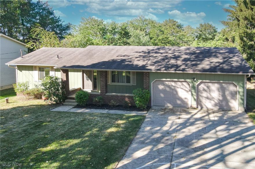 Charming Ranch Home in Tallmadge Local Schools  This lovely home features two spacious bedrooms on the main floor, plus an additional room in the basement that can serve as a third bedroom or a cozy office space. As you pull up, you’ll immediately notice the charming character of the home, highlighted by the inviting covered front porch—a perfect spot to relax with a morning coffee. Step through the front door and into the generous living room, which seamlessly flows into the dining area, creating an open and airy atmosphere.  Adjacent to the dining area is the well-appointed kitchen. Just off the kitchen, you’ll find a delightful screened-in porch that overlooks the backyard, offering a tranquil space for outdoor enjoyment. Step outside onto the large deck, perfect for entertaining or soaking up the sunshine. Down the hall from the living and dining areas, you'll discover a full bathroom and the two comfortable bedrooms, providing convenient single-level living.  Venture down the stairs to the finished basement, where you’ll find an additional room previously used as a bedroom, but easily convertible to an office or guest room. The basement also features another full bathroom and a spacious finished living room. Plus, the utility room includes a laundry space for added convenience. This home comes complete with a two-car attached garage, providing ample storage and parking.  The exterior spigots are hooked to the well but the rest of the home is public water. Recent updates include a new furnace and A/C (2023), gutter covers (2019), glide-out lower kitchen cabinets (2020), a double oven range (2021), a 7-foot privacy fence (2022), and window tinting on the west-facing window (2020). With so much to offer, this charming ranch is a must-see! Call today to schedule your private tour!