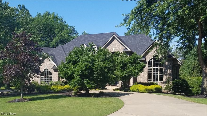 Exquisitely tasteful colonial with 1st floor master. A rare offering on 1.67 lushly landscaped acres. Luxury finishes. Walls of windows grace its light-filled rooms. Gorgeous deep rich wood flooring. Meticulous attention to detail throughout. Beautiful 2 story entry open to the living area with serene wooded views. Vaulted 1st floor office with fireplace. Fabulous kitchen with high volume ceilings, skylights, and high end appliances (quartzite waterfall countertops, Dacor stove and Wi-Fi hood, subzero refrigerator, Bosch dishwasher, stunning backsplash and custom hardware.) An exercise in refinement.  Grand master suite with fireplace and 2 walk-in closets. Spa bath with double sinks, frameless shower, and soaking tub with a private staircase to the crystalline waters of the marvelous in-ground pool. Walk-out lower level with simply superior finishes, fireplace, exercise room, theater area, game area, guest bedroom and bath and bar. 2nd floor with two additional bedrooms and baths. A sensational wooded property with a private lake. An amazing home on a private cul-de-sac street in Avon. Wonderful location with excellent access to shopping and I-90, just West of the Westlake line.