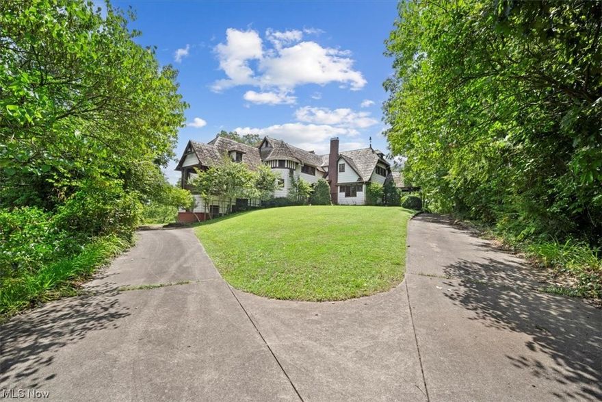 A country estate sited on 12.34 acres of private park like grounds minutes from the historic city of Marietta, Ohio. Located on one of the highest points in the county offering panoramic views of the Muskingum River and abutting an 800 acre nature preserve. 1915 Old World architecture that reflects the Tudor style with an exuberant display of rich original detailing. The floor plan is a modern approach to living with first floor owners en suite, banquette size fireside dining, 18x31 living room which opens to an orangery and covered porch, eat in kitchen with pantry and home office. Upper level gallery leads to guest bedrooms and two full baths. Grand light filled rooms are ideal for parties, events or relaxing. This landmark property offers an investment opportunity or your own private retreat. A detailed list of amenities are available.