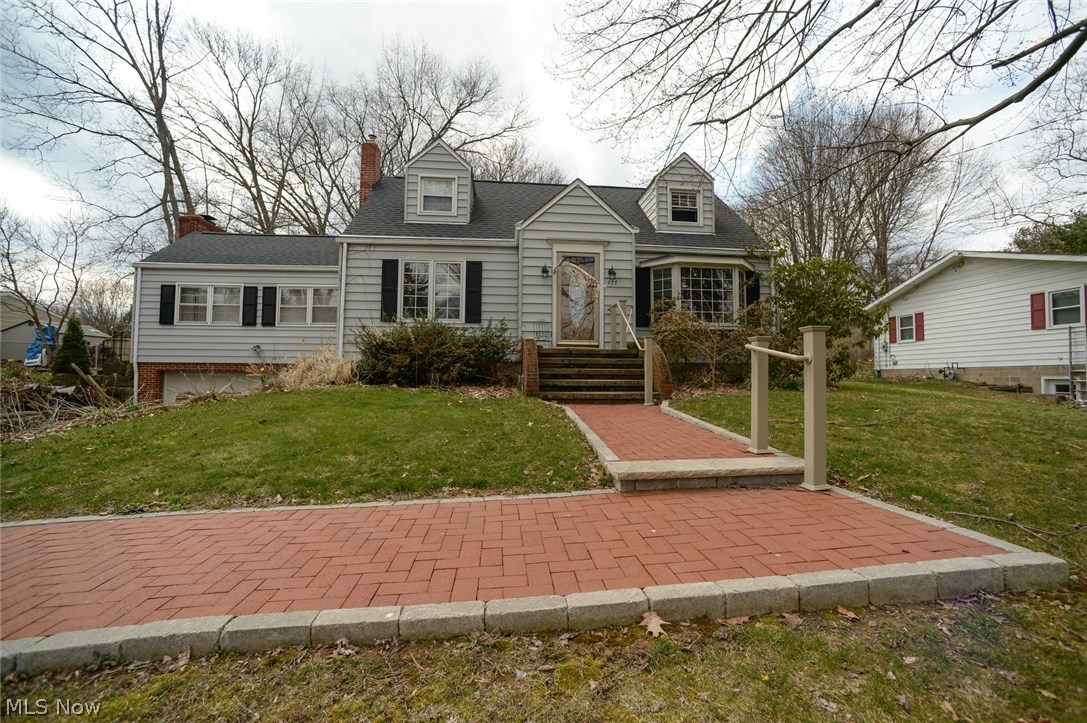 The Tallmadge home you have been looking for is here! Over 2000 square foot, half acre lot, 3 bedrooms, 3 bathrooms and beautiful updates. The home is set back off of Alandale with a lovely, large front yard and private feel. Gorgeous original hardwood floors in the living room, formal dining room and 2 upstairs bedrooms. Incredible open kitchen with tons of granite countertops, an island and classic glass backsplash. More than plenty solid oak cabinets and the stainless steel appliances stay. Massive family room with 2 walls of windows and a working, wood burning fireplace. Large master bedroom with walk-in closets and an en-suite bathroom. There is also a half bath/ laundry room combo on the main level. Up stairs you will find 2 additional, nice sized bedrooms with built-in storage, a linen closet and another full bathroom. All the bedrooms have ceiling fans. On the lower level there is a rec room with built in counters/desk/storage. There is also a workshop area, anothe