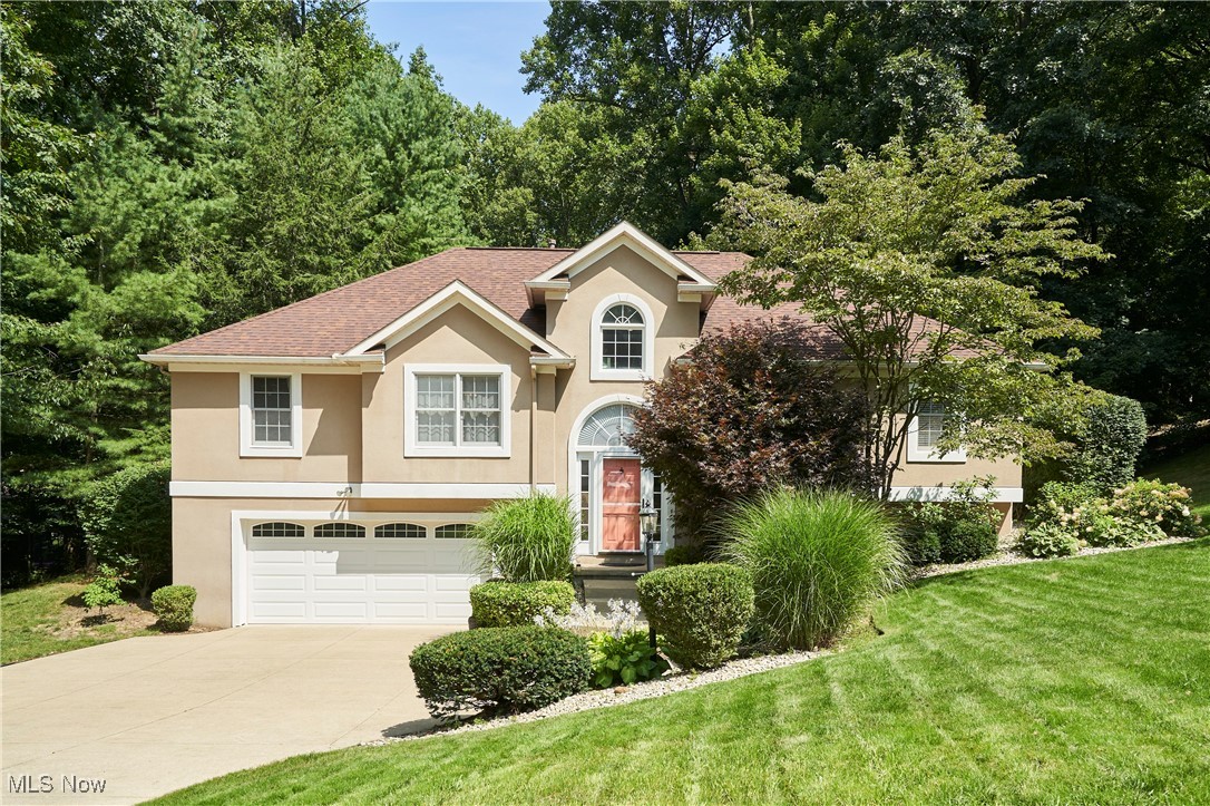 Welcome to this inviting home located in the highly sought-after Revere School District. This stunning suburban residence w/Neoclassic influences offers the perfect blend of privacy and community. Tucked away at the end of a quiet cul-de-sac, the home sits on a picturesque, scenic, wooded half-acre lot with a gentle stream. The main floor features a thoughtfully designed layout with a mixture of hardwood floors and carpet, highlighted by a spacious master suite w/double sink vanity, soaking tub, separate shower, tile flooring and a walk-in closet, privately situated on one side of the home. The open-concept living area includes the living room, kitchen and dining areas and serves as a natural divider from the 2 additional bedrooms. The living room boasts vaulted ceiling, skylights and large windows filling the space w/natural light. A gas FP adds warmth and charm in the winter. The kitchen is beautifully equipped w/granite counters, a pantry, gas range, and reverse osmosis water system connected to the refrigerator/ice maker. Dining options include a formal dining rm, cozy dinette & bar seating. Also on the main level are 2 additional bedrooms separated by a 2nd bathroom. The lower level offers a half bath, laundry area w/washer & dryer and tile flooring, mechanical room and a large finished family room. Additional highlights include a radon mitigation system and backyard shed. The property is ready for fiber optic internet service. This home offers the perfect comination of comfort, style and convenience. Don't miss the opportunity to make it yours.