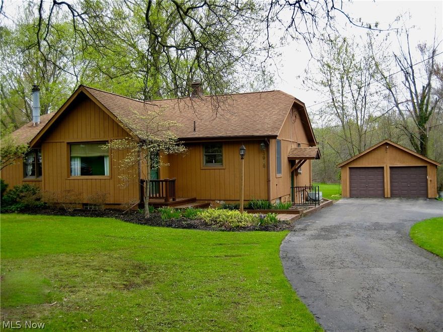 Lovely Ranch style home situated on 3.76 peaceful acres in Canfield Township Features Equipped Kitchen, Great room/Dining combination with gas Fireplace, Charming Foyer with door access to front deck, Master Br with half bath and Main full bath w/walk-in Shower: Br2 has a double closet and Stacking Washer and Dryer Closet. The Sun Room features sliding glass doors to the rear raised deck, 2 large closets and built-ins for storage. It could also be used as a 3rd bedroom. This  charming home Features Andersen windows and Oak trim & doors throughout; Recent upgrades include Newer Laminate flooring, New Water heater, Updated Electric throughout and New Sump pump. The Roof is 12 yrs old. The Basement also has Washer/dryer hookup, an extra utility sink and a Shower as well as a workshop room and 2 Storage rooms. spacious 2-car detached garage with Man-door and a New door opener.