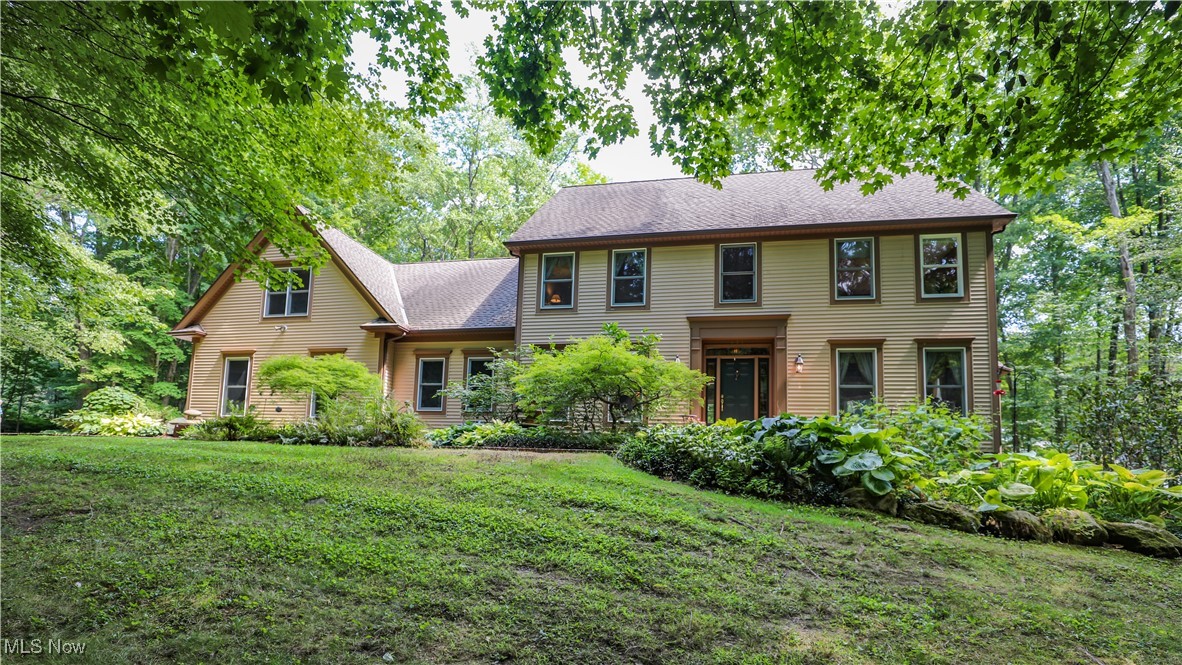 A private estate where elegance meets comfort. Set on 3.66 beautifully wooded acres, this distinguished residence offers exceptional privacy and refined living just minutes from Aurora's finest amenities. Inside, discover five spacious bedrooms, each with its own en-suite bath, including two primary suites thoughtfully placed for both convenience and retreat. A grand two-story foyer with a chandelier sets the tone, leading to a formal living and dining rooms with rich millwork, tray ceilings and timeless crown molding. The heart of the home is the gourmet kitchen, designed for both daily living and entertaining. Granite counters, a center island, double ovens, and an adjoining dining area open seamlessly into the family room and sun-filled octagonal sunroom with fireplace. The walk-out lower level extends the living space with a striking wood-clad library and fireplace, an additional primary suite, and access to a landscaped stone patio. Outdoor living continues with a full-length composite deck overlooking your private wooded setting. Additional features include a 3-car garage with electric openers, dual furnaces and water heaters, abundant storage and a long paved drive ensuring seclusion and approach. Your Aurora sanctuary awaits. Schedule your private showing today. Please click virtual tour link.