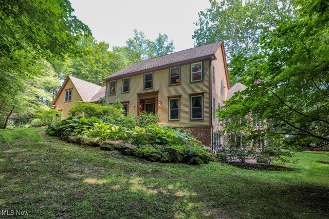 A private estate where elegance meets comfort. Set on 3.66 beautifully wooded acres, this distinguished residence offers exceptional privacy and refined living just minutes from Aurora's finest amenities. Inside, discover five spacious bedrooms, each with its own en-suite bath, including two primary suites thoughtfully placed for both convenience and retreat. A grand two-story foyer with a chandelier sets the tone, leading to a formal living and dining rooms with rich millwork, tray ceilings and timeless crown molding. The heart of the home is the gourmet kitchen, designed for both daily living and entertaining. Granite counters, a center island, double ovens, and an adjoining dining area open seamlessly into the family room and sun-filled octagonal sunroom with fireplace. The walk-out lower level extends the living space with a striking wood-clad library and fireplace, an additional primary suite, and access to a landscaped stone patio. Outdoor living continues with a full-length composite deck overlooking your private wooded setting. Additional features include a 3-car garage with electric openers, dual furnaces and water heaters, abundant storage and a long paved drive ensuring seclusion and approach. Your Aurora sanctuary awaits. Schedule your private showing today. Please click virtual tour link.