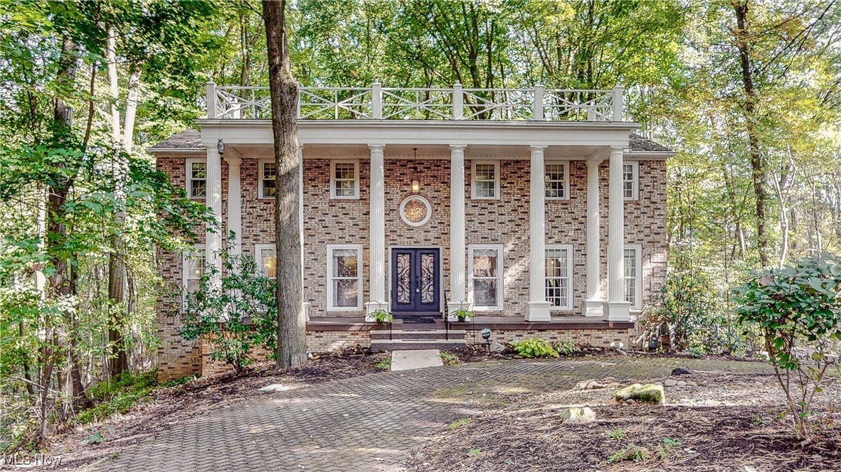 What a showstopper! Welcome home to 1785 Fairlawn Knolls Dr! Discover this extraordinary home that blends comfort, style, and entertainment, all set on 1.3 serene wooded acres in sought-after West Akron. This expansive property offers a rare combination of luxury and privacy. You'll be greeted with gorgeous double doors and a dramatic 2-story foyer that showcases a dual staircase and a beautiful marble inlay and grand chandelier. The primary suite is complete with an updated bath featuring a jacuzzi tub and custom tile shower. All secondary bedrooms are large with beautiful wood floors and oversized closets. The lower level features the 54x31 in-ground, indoor swimming pool with hot tub. You'll also discover the large entertainment room with a gas/woodburning fireplace with gas starter, sauna, and full bathroom. The beautiful updated eat-in kitchen with ample cabinet/counter space is absolutely idealic. There is also an oversized dining room with 12ft wide windows and a nicely appointed wet bar. The warm family room with a large wood burning fireplace leads to an outdoor living space that is absolutely incredible. The 54x31 composite covered deck is complete with an outdoor kitchen! This beautiful treehouse sits on 1.3 acres that runs along the Sand Run Metropark.