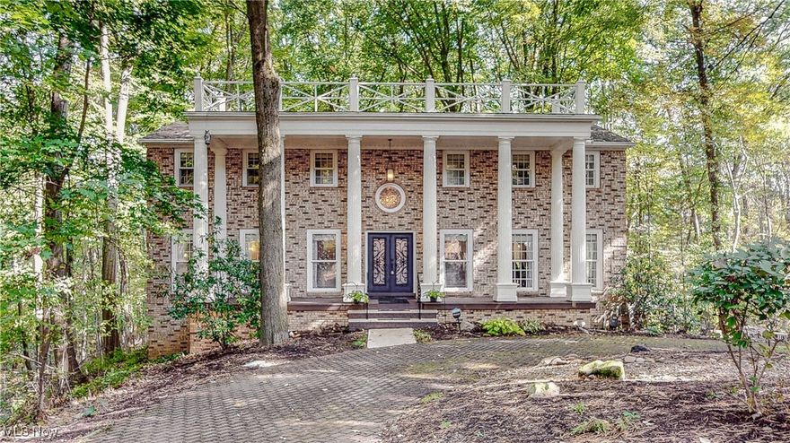 What a showstopper! Welcome home to 1785 Fairlawn Knolls Dr! Discover this extraordinary home that blends comfort, style, and entertainment, all set on 1.3 serene wooded acres in sought-after West Akron. This expansive property offers a rare combination of luxury and privacy. You'll be greeted with gorgeous double doors and a dramatic 2-story foyer that showcases a dual staircase and a beautiful marble inlay and grand chandelier.   The primary suite is complete with an updated bath featuring a jacuzzi tub and custom tile shower.  All secondary bedrooms are large with beautiful wood floors and oversized closets.  The lower level features the 54x31 in-ground, indoor swimming pool with hot tub.  You'll also discover the large entertainment room with a gas/woodburning fireplace with gas starter, sauna, and full bathroom.  The beautiful updated eat-in kitchen with ample cabinet/counter space is absolutely idealic. There is also an oversized dining room with 12ft wide windows and a nicely appointed wet bar.  The warm family room with a large wood burning fireplace leads to an outdoor living space that is absolutely incredible.  The 54x31 composite covered deck is complete with an outdoor kitchen! This beautiful treehouse sits on 1.3 acres that runs along the Sand Run Metropark.  Don't miss out on your chance to call this place home.