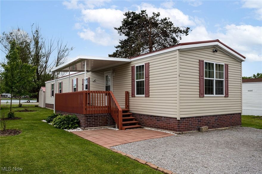 Beautiful 3-Bedroom, 2-Bath Home with Lakeview & Resort-Style Amenities: Welcome to this stunning 2018 manufactured home nestled in a quiet park next to a scenic campground. Enjoy the serenity of lakefront living with fishing just feet away with access to a sparkling pool for those warm summer days. Go outside to relax or entertain on two covered decks or the tasteful brick back patio, surrounded by gorgeous perennial landscaping that blooms beautifully year after year. The main exterior feature is a large 12’ x 16’ storage building for all your tools and toys, and space for 3 car-parking. This spacious home has been tastefully updated with a brand-new roof, new kitchen cabinets and countertops, new flooring and trim throughout.  Inside, you’ll find a large living area, a generously sized pantry, open kitchen, and plenty of closet space in each of the three bedrooms. Two beautiful full baths, washer and dryer hookups, and a Culligan water system installed in 2024. With nothing left to do but move in, this home offers the perfect combination of comfort, convenience, and peaceful atmosphere. Whether you’re looking for a weekend getaway or year-round living, this is the one you’ve been waiting for! Call today for a tour!