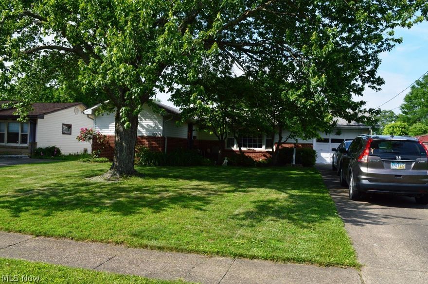 All first floor living, ranch style home.  Spacious kitchen with plentiful cabinets and abundance of cabinet space, with lots of natural light from skylight and offers a pot rack and tile backsplash, open window pass through into the large family room with several built-ins and sliding door to back patio that leads you to large flat lot.  Kitchen also is open for formal dining area and oversized for living area with beautiful picture window.  Kitchen, living, dining into hallway all offer beautiful new laminate floors, bathroom has been partially remodeled with new flooring and a bath fitter tub that offers a warranty.  New hot water tank, and NEW ROOF being installed June 2018.  Single car garage, fresh paint throughout in the past few years.