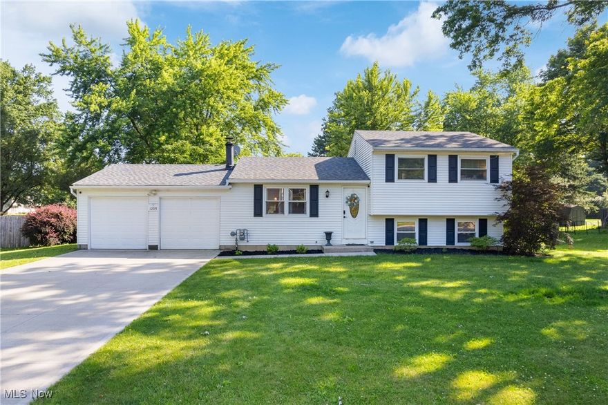 Welcome to 1295 Hibbard Drive, ideally located in Stow near local parks, shopping, and everyday amenities. This 4 level split style home offers a comfortable and functional layout with thoughtful updates throughout. As you enter you are welcomed by a spacious living room with a beautiful brick fireplace. The dining area seamlessly flows into the updated kitchen that has beautiful cabinetry, a tile backsplash, and newer stainless steel appliances (2018). Heading upstairs you will find the primary bedroom, an updated full bathroom, and two additional bedrooms that can be utilized to fit your needs! The lower level adds even more living area with a second living room, a dedicated office, and another full bathroom. A utility room and ample storage space complete the lower level. Off the back of the home is a spacious screened in porch that over looks the large backyard which is perfect for entertaining or relaxing. Other notable updates include, a new roof (2018), new driveway/walkway (2018), new furnace (2019), new AC (2019), new sump pump (2019), and new hot water heater (2024). You do not want to miss out on this one!