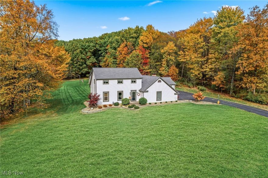 MOVE IN CONDITION & AVAILABLE IMMEDIATELY for Possession! Welcome to this beautifully preserved four-bedroom colonial nestled on over 2.6 acres within the highly sought-after Canfield School District. This unique property offers a multitude of possibilities, including a potential private in-law suite with ample space for a second kitchen, making it an ideal choice for multi-generational living. It also boasts a stunningly updated open kitchen. Step inside and be greeted by a thoughtfully updated home featuring:- Roof and siding replaced in 2020 - Ohio State Waterproofing was installed in 2016 with a lifetime transferable guarantee, and a new sump battery was installed in 2025- A septic aerator installed in 2025 - A kitchen remodel completed in 2017 and a master bath remodel completed in 2011 - A half-bath remodel completed in 2013 - All doors and windows replaced in 2010 - A garage door replaced in 2020 Outdoors, the property features charming two-out buildings with electric power, a larger shed equipped with a portable heat source, perfect for hobbies, animals, or extra storage. The gorgeous backyard offers a beautiful view and is truly special—private, peaceful, and ready for entertaining, gardening, or simply relaxing.  This home comes with a one-year home warranty. This rare find combines ample acreage, thoughtful updates, and an ideal location in Canfield. It’s conveniently close to the Canfield Fairgrounds and the Millcreek Bike Trail, making it a fantastic lifestyle opportunity.