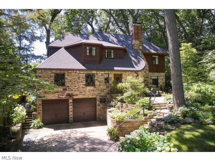 Private wooded retreat, nestled in nature but right in the city! One-of-a-kind updated English Tudor with 3 BRs and 2.5 BAs on a secluded & desirable road backing up to extensive ravine providing tons of privacy and long views! This home has undergone extensive renovations all while keeping its nearly century-old charm intact (see the rich stone, original solid doors, iron windows, and woodwork/molding throughout!). 1st floor features hardwood floors, spiral staircase, formal dining room w/ built-ins, spacious living room with built-ins and newer gas fp adjacent to 4 season sun room w/ Pella windows and slider to patio, bright and airy huge remodeled eat-in kitchen w/ wet bar, SS appliances including gas range and hood, granite counters, recessed lighting, butler’s pantry & stairwell w/ access to backyard, plus a half bath. 2nd fl hosts master suite with sitting room and full bath (butler’s stairwell enters here), 2 add’l bedrooms (one with 2 closets), and another full bath. Add'l feat