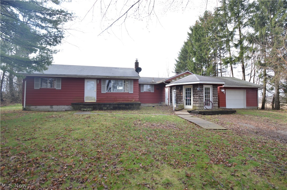 Two bedroom ranch on 0.69 acres in Springfield Township and Columbiana School District. The main level of this home plays host to a welcoming foyer with slate floor that leads to a rustic family room with fireplace; a kitchen; dining room; living room; two bedrooms and a full bath. A full basement provides ample storage. Exterior features include a one car attached garage, enclosed rear porch, and barn with a small fenced pasture. Forced air oil heat with central air conditioning. This home is in need of some TLC and is being sold as is.