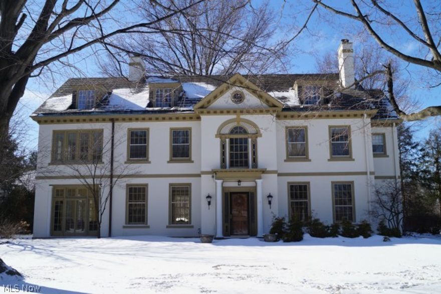 Landmark Stucco Georgian In The Historic Euclid Golf Allotment.  Features Light-Filled Rms with Beautiful Architectural Details: Grand Central Foyer with Reverse Staircase, Step-Down Living Rm with Arched French Doors & Adjoining Tiled Sun-Rm.  Gorgeous Wood-Paneled Dining Rm with Fireplace. Fabulous Kitchen Renovation with High-End Appliances , Custom Cabinetry, Heated Floors, & Open Eating Area or Family Rm Space.  Den/Office On First w/Built-Ins & French Doors To Brick Patio.  Second Floor Features 3-Room Master Suite, 3 Additional Bedrms, 3 Full Baths, and Laundry Rm. Additional Bonus Rms and Full Bath w/Separate Staircase to Outside Above The Oversized 2+ Car Attached Garage. Remarkable Third Floor w/Maple Floors & Fireplace Plus Extra Bedrm w/Full Bath Potential.  Extensive Slate Roof & Copper Flashing/Gutter Restoration. Water-Proofed Basement. Lawn Sprinkler.  Walk To Cedar Fairmount Restaurants, Bakeries, & Grocery.  Five Minutes To Univ. Hospitals, Case, & Cleveland Clinic.