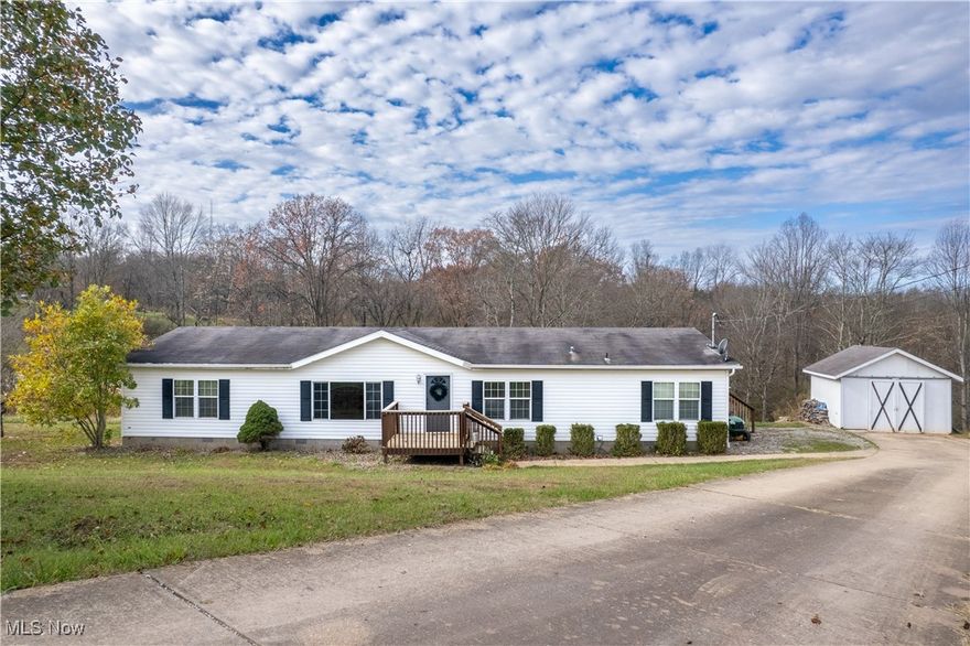 Welcome to a home that is not just comfortable, it’s a lifestyle.  Situated on 12.3 acres in a secluded setting, you have space to work, play and roam.  The majority of acreage is wooded, with trails and a creek.  The house has a fenced backyard and cleared non wooded areas. You can enjoy the beauty from the large back deck and screened porch.  There is a storage building and darling new chicken coop.  Inside you have 2 good sized bedrooms with a full bathroom between them at one end of the house.  At the other end you find a huge owner’s suite with a giant bathroom complete with 2 walk in closets, double vanity, soaking tub, and separate shower.  The open concept living room features a large picture window. Pull up a barstool at the big kitchen island, or there is a dining area looking into the kitchen.  From the kitchen you can enter the laundry room and walk in pantry.  From the dining room you can go through sliding glass doors onto the deck, or into the cozy rec room with fireplace.  If you want to feel out of town and in your own private paradise, while being close to conveniences, then contact your real estate professional today,