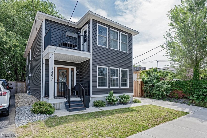 Enjoy city life at its best in this spectacular colonial in the heart of Ohio City! Originally built in 1900, this home was completely transformed in 2020 with modern smart features and on-trend, high quality finishes throughout. Plus, it is tax abated until 2035! Wide plank hardwood floors greet you in the foyer and flow into the open kitchen and living area. With quartz counters, a waterfall island, a farmhouse sink, and a custom bar area, the kitchen will take your breath away. Smart appliances make living a breeze, including a hands free sink, a ZLine 36” professional range and hood, a Samsung smart fridge, dishwasher, and microwave. The kitchen overlooks the great room, which features a coffered fireplace and large windows to welcome natural light. Sliding doors open out to the back deck, and the backyard is fully fenced-in with a low-maintenance turf lawn, perfect for pets. One bedroom and one full bathroom are on the first floor, perfect for a home office or guest suite. Upstair