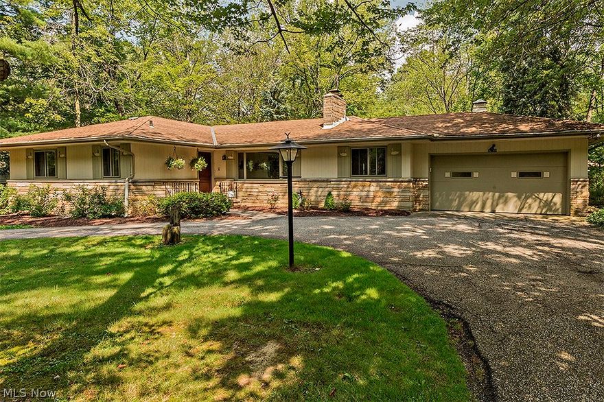 Unmatched in quality or setting, this lovely ranch offers easy living and fantastic updates all on a picturesque lot. Walking in the living room, you will notice gorgeous hardwood floors opening up to a formal dining area. From there, you’re lead to an updated kitchen equipped with stainless appliances, granite counters, as well as ample cabinet and counter space. Entertaining is made enjoyable with a three season sun room off the kitchen overlooking a beautiful wooded backyard. Step down to the family room with a wood-burning fireplace and wood paneled walls, making for a comfortable warm and inviting hearth room. A spacious master suite offers an attached full bathroom. A renovated hall bathroom features granite counters and a customized built-in closet. Two more bedrooms round out the main level. The lower level boasts plenty of additional storage space and a huge recreation room, great for additional living space or play room. Other highlights include completely upgraded electrical