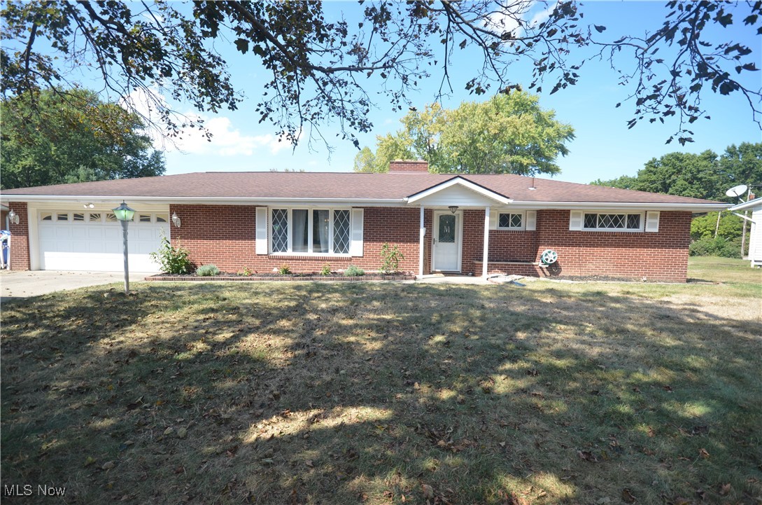Tallmadge brick ranch in Stillmeadow Estates w beautiful updated kitchen and bathroom all sitting on a roughly half acre lot! Open living rm with brick wood burning fireplace w raised hearth and laminate flooring. Incredible daylight from the large picture window and the open flow to the eating area with another large window. LVP flooring in the kitchen and dining area plus updated cabinets, granite counters, backsplash plus the appliances all stay- refrigerator, cooktop, oven, microwave, dishwasher- even the washer and dryer! The kitchen offers great storage options and decorative display cabinets. A convenient half bath is right off of the dining area. The master bedroom is a nice size along with the updated second bedroom with new doors, carpeting, ceiling fan and more. The full bath is updated as well with a large vanity w granite counters, LVP flooring and a beautiful custom tile shower surround. The 3rd bedroom is accessible from the hall or kitchen and includes built in cabinets as well as a closet and access to the sun room for additional living space. The large sunroom has baseboard heat and a slider to the large, flat back yard w storage shed. The 1st floor laundry is accessible through the garage and includes a utility sink, hanging rack and additional storage. 2 Car attached garage w electric, water, drain and garage door opener and attic access. Updates include: '25 Bedroom update, closet organization, garage outlets. '24 Bathroom. '23 Electrical panel. This is an incredible value for a brick ranch in Stillmeadow Estates- close to all of the schools, Rec Center, Maca Pool, Shopping (Meijer, Aldi,Wal-Mart, Lowe's, Menards, Resturants & more) plus highway access and with slab construction there's no basement to worry about!