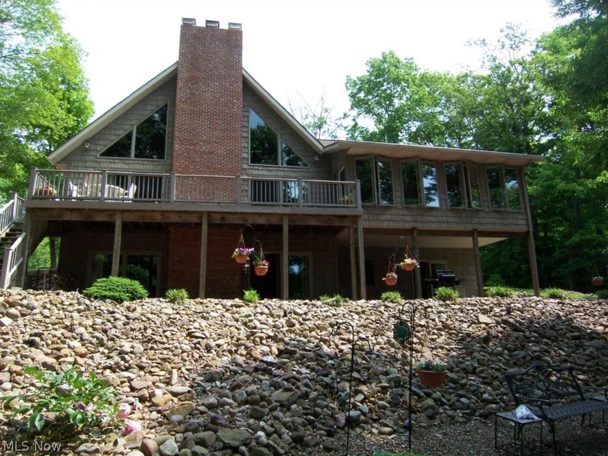 Want a lakefront home in the woods? This is it! Gorgeous home with all the top quality finishes. Exterior is mostly low maintenance with lots of ground covers, cedar shake style vinyl siding, Trex decking, paved drive, and concrete seawall and "boardwalk". Interior has great open plan made up of a great room, dining room, and kitchen with a brick fireplace rising all the way to a beautifully finished vaulted wood ceiling. Loft overlooks great room and has a bedroom and full bath as well. Open deck off DR and great room also accesses finished sun room. Lower level has big family room with FP and wet bar and 2 sliding glass doors to covered patio. Huge lot that is very private. Property on one side of home is village property and the current owner owns the lot on the other side. This lot (1419)is also available for sale with the home for an extra $89,900. Buy both and make a great deal. Beautiful lakefront home.