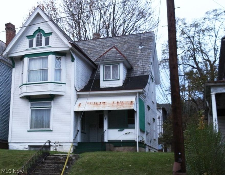 Great investment property. 3 BR, 1.5 BA, LR w/decorative fireplace, Formal DR, main fl laundry off kitchen.  Level back yard w/alley access for off street parking.  Needs some love OR Nice level city lot to build a new home if desired.